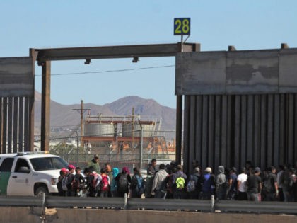 Central American migrants surrender to United States Border Patrol officers after crossing to El Paso, Texas from Ciudad Juarez, Chihuahua state, Mexico on April 21, 2019. (Photo by Herika Martinez / AFP) (Photo credit should read HERIKA MARTINEZ/AFP/Getty Images)