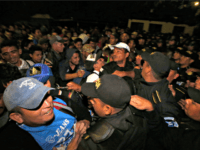 Honduran migrants wait to enter Guatemala at the border crossing in Agua Caliente, Tuesday, Jan. 15, 2019. The latest caravan of Honduran migrants hoping to reach the U.S. has crossed peacefully into Guatemala, under the watchful eyes of about 200 Guatemalan police and soldiers. (AP Photo/Moises Castillo)