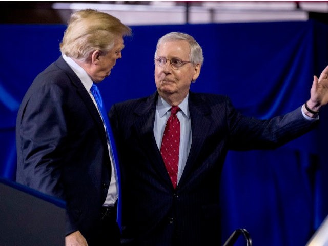 President Donald Trump, left, invites Senate Majority Leader Mitch McConnell of Ky., right, onstage as he speaks at a rally at Alumni Coliseum in Richmond, Ky., Saturday, Oct. 13, 2018. (AP Photo/Andrew Harnik)