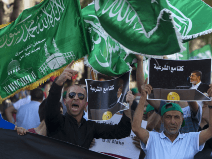 Members of the Arab-Israeli Islamic Movement chant slogans during a protest in support of deposed Egyptian president Mohamed Morsi (portrait) and against the army crackdown on Muslim Brotherhood supporters, in the northern Israeli city of Nazareth on August 17, 2013. AFP PHOTO / AHMAD GHARABLI (Photo credit should read AHMAD …