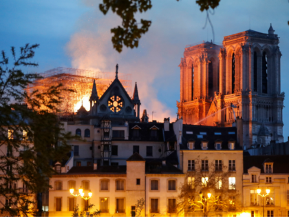 Firefighter douse flames billowing from the roof at Notre-Dame Cathedral in Paris on April