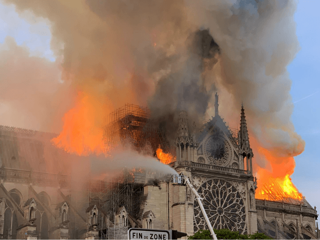 TOPSHOT - Flames and smoke are seen billowing from the roof at Notre-Dame Cathedral in Paris on April 15, 2019. - A fire broke out at the landmark Notre-Dame Cathedral in central Paris, potentially involving renovation works being carried out at the site, the fire service said.Images posted on social media showed flames and huge clouds of smoke billowing above the roof of the gothic cathedral, the most visited historic monument in Europe. (Photo by Patrick ANIDJAR / AFP) (Photo credit should read PATRICK ANIDJAR/AFP/Getty Images)