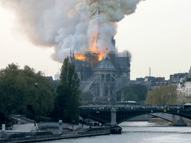 TOPSHOT - Smokes ascends as flames rise during a fire at the landmark Notre-Dame Cathedral in central Paris on April 15, 2019 afternoon, potentially involving renovation works being carried out at the site, the fire service said. (Photo by FRANCOIS GUILLOT / AFP) (Photo credit should read FRANCOIS GUILLOT/AFP/Getty Images)