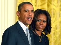 US President Barack Obama jokes with Olympians as First Lady Michelle Obama looks on during a ceremony to honor the US 2014 Sochi Olympic and Paralympic Winter Games teams in the East Room at the White House in Washington, DC, on April 3, 2014. AFP PHOTO/Jewel Samad (Photo credit should …