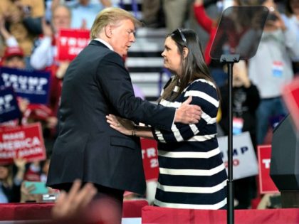 US President Donald Trump (L) embraces White House Press Secretary Sarah Huckabee Sanders during a Make America Great Again rally in Green Bay, Wisconsin, April 27, 2019. (Photo by SAUL LOEB / AFP) (Photo credit should read SAUL LOEB/AFP/Getty Images)