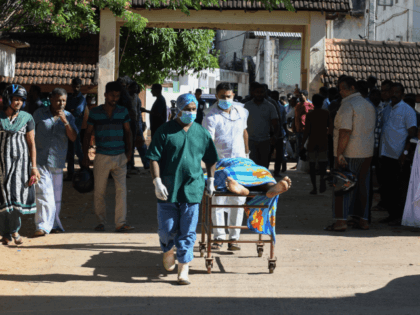 Graphic content / Sri Lankan hospital workers transport a body on a trolley at a hospital morgue following an explosion at a church in Batticaloa in eastern Sri Lanka on April 21, 2019. - A series of eight devastating bomb blasts ripped through high-end hotels and churches holding Easter services …