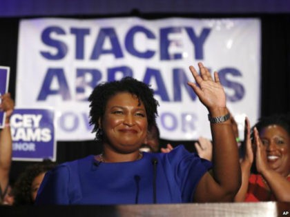 FILE- In this May 22, 2018, file photo Georgias Democratic gubernatorial candidate Stacey Abrams waves in Atlanta. Abrams is trying to reach voters who donât usually vote in midterm elections in the hopes to drive up turnout in her race against Republican Brian Kemp. (AP Photo/John Bazemore, File)