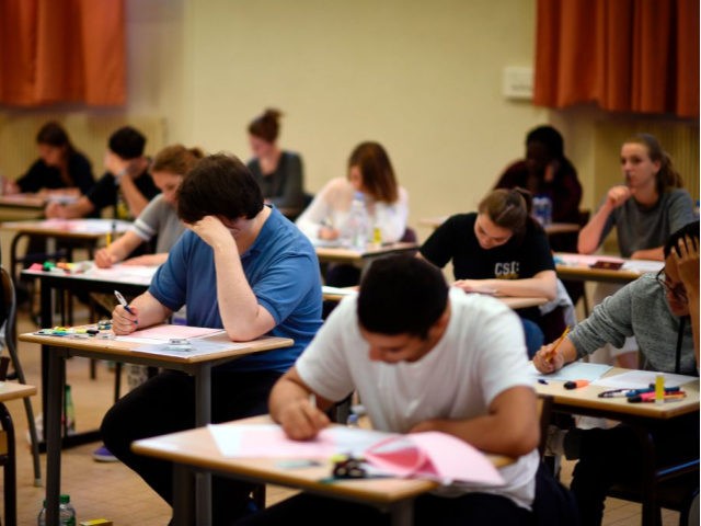 High school students take the philosophy exam, the first test session of the 2015 baccalaureate (high school graduation exam) on June 17, 2015 in Paris. Some 684,734 candidates registered for the exam to be held until June 24, 2015 in 4,200 examination centres. AFP PHOTO / MARTIN BUREAU / AFP …