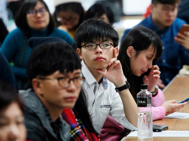 Hong Kong pro-democracy student leader Joshua Wong, center, listens to speakers during a democracy forum in Taipei, Taiwan, Thursday, Jan. 14, 2016. Taiwan will hold its presidential elections on Jan. 16, 2016. (AP Photo/Chiang Ying-ying)