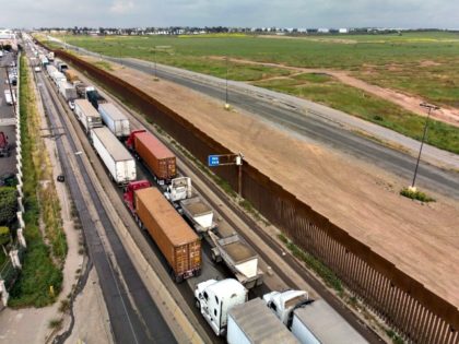 Aerial view of cargo trucks lining up to cross to the United States near the US-Mexico bor