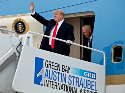 President Donald Trump accompanied by Sen. Ron Johnson, R-Wis., right, arrives at Green Bay Austin Straubel International Airport in Green Bay, Wis., Saturday, April 27, 2019, for a rally. (AP Photo/Andrew Harnik)