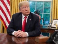 Trump at Resolute desk (Saul Loeb / AFP / Getty)