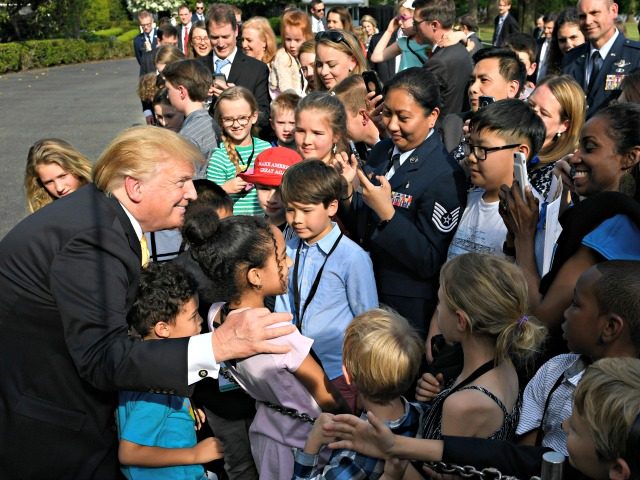 President Donald Trump greets children after speaking to them on the South Lawn of the White House in Washington, Thursday, April 25, 2019, as part of the activities for Take Our Daughters and Sons to Work Day at the White House. (AP Photo/Susan Walsh)