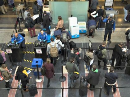Travelers at a security checkpoint in Ronald Reagan National Airport in Washington.CreditC