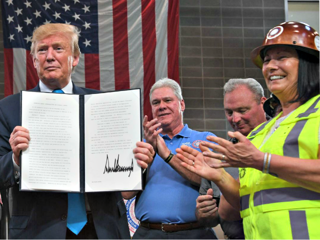 US President Donald Trump signs executive orders on energy and infrastructure at the International Union of Operating Engineers International Training and Education Center in Crosby, Texas, on April 10, 2019. Credit: JIM WATSON/AFP/Getty Images