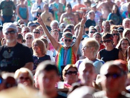 BETHEL, NY - AUGUST 15: A fan flashes the peace sign during the concert marking the 40th anniversary of the Woodstock music festival August 15, 2009 in Bethel, New York. On August 15-17 in 1969 an estimated 400,000 music fans gathered on Max Yasgur's farm in Bethel, New York for …