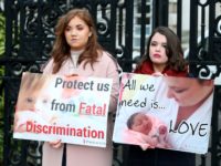 Pro-life, anti-abortion activists hold placards as they protest outside of Belfast High court in Belfast, on January 30, 2019, where Northern Ireland resident and campaigner Sarah Ewart, who after having been diagnosed with a fatal foetal abnormality in 2013 travelled to England for a termination, is a bringing a legal …