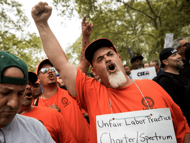 NEW YORK, NY - SEPTEMBER 18: Members of IBEW Local 3 cheer during a rally of hundreds of union members in support of IBEW Local 3 (International Brotherhood of Electrical Workers) at Cadman Plaza Park, September 18, 2017 in the Brooklyn borough of New York City. More than 1800 members …