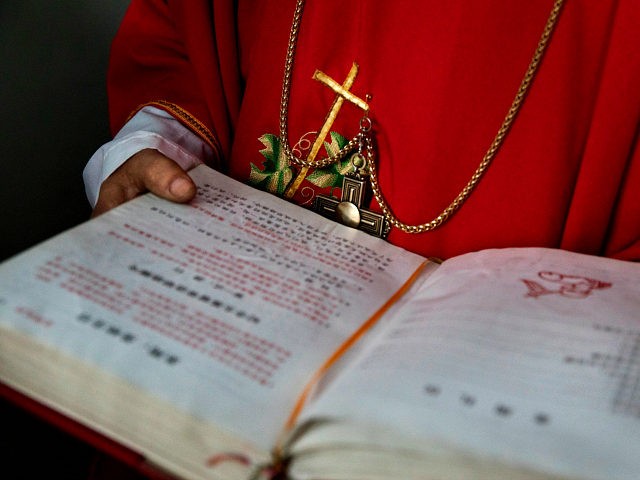 SHIJIAZHUANG, CHINA - APRIL 09: (CHINA OUT) A Chinese Catholic deacon holds a bible at the Palm Sunday Mass during the Easter Holy Week at an 'underground' or 'unofficial' church on April 9, 2017 near Shijiazhuang, Hebei Province, China. China, an officially atheist country, places a number of restrictions on …