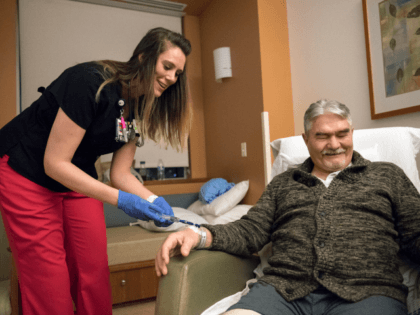 Christina Gay, left, administers medication to Gene Wickstrom of Cathlamet during Gay's April 5, 2018, night shift at Legacy Salmon Creek Medical Center in Vancouver, Washington. Gay studied nursing at Clark College and Washington State University Vancouver. (Photo by Alisha Jucevic/The Columbian via AP)