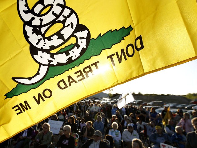 A Don't Tread On Me flag flies over protesters during a rally at Leo O'Laughlin Inc. on the eve of President Barack Obama's visit to Macon, Mo. Tuesday evening, April 27, 2010, in Macon. The protest was organized by the Missouri Republican Party and a tea party group called the …