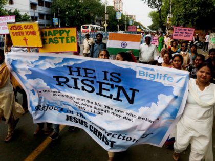 Indian Catholics walk with posters during an Easter procession in Kolkata, India, Sunday, April 21, 2019. Christians around the world are celebrating Easter commemorating the day when according to Christian tradition Jesus was resurrected in Jerusalem two millennia ago. (AP Photo/Bikas Das)