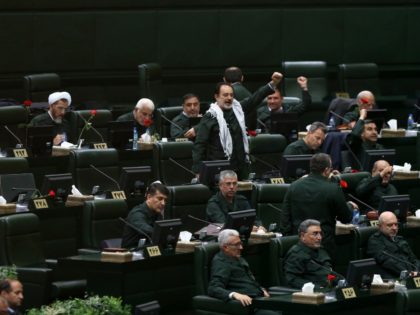 Wearing the uniform of the Iranian Revolutionary Guard, lawmakers chant slogan during an open session of parliament in Tehran, Iran, Tuesday, April 9, 2019. Chanting "Death to America," Iranian lawmakers convened an open session of parliament Tuesday following the White House's decision to designate Iran's elite paramilitary Revolutionary Guard a …