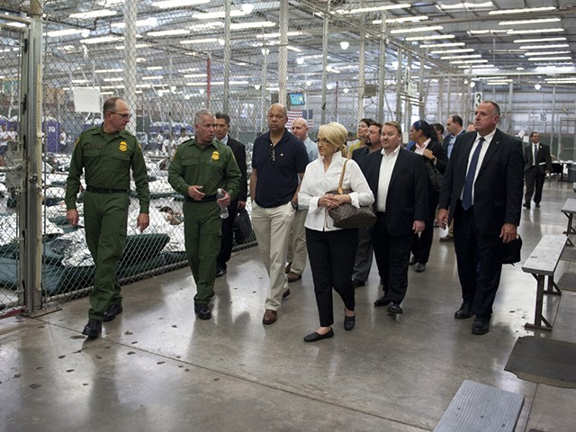 Border Patrol officers escort Homeland Security Secretary Jeh Johnson and Gov. Jan Brewer through the department’s Nogales processing facility for immigrant children. (Photo courtesy Barry Bahler/Department of Homeland Security)