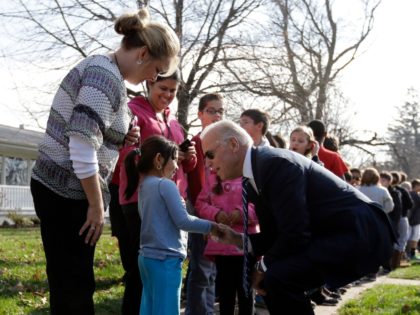Vice President Joe Biden talks to a young girl as he met with students outside two schools, Thursday, Nov. 1, 2012, in Muscatine, Iowa, after a campaign stop. (AP Photo/Matt Rourke)