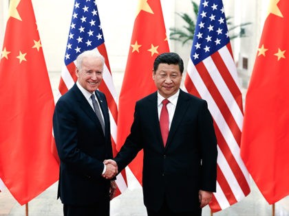 BEIJING, CHINA - DECEMBER 04: Chinese President Xi Jinping (R) shake hands with U.S Vice P