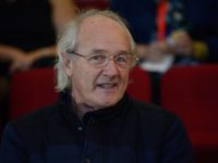 John Shipton, the biological father of WikiLeaks founder Julian Assange waits to hear his son deliver a keynote speech via video from the Ecuadorian embassy in London to the 19th International Symposium on Electronic Art at the University of Sydney on June 13, 2013. Assange on June 11 called the …