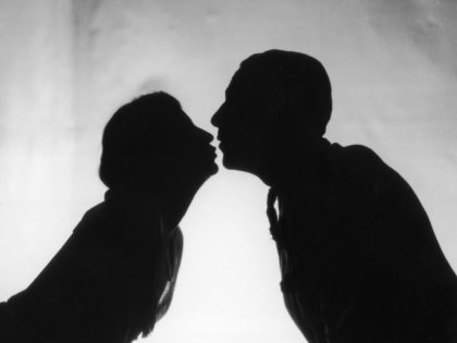 1st October 1926: A couple kissing in a scene from the play 'Just A Kiss' at the Shaftesbury Theatre, London. (Photo by Sasha/Getty Images)