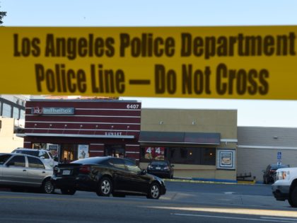 Police tape cordons off an area outside a Jack in the Box restaurant in Hollywood, Califor
