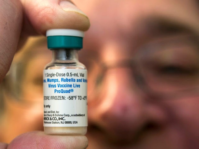 FILE - In this Thursday, Jan. 29, 2015 file photo, a pediatrician holds a dose of the measles-mumps-rubella (MMR) vaccine at his practice in Northridge, Calif. A new study published in the journal Science suggests the measles vaccine not only prevents measles, but may also help the body ward off …