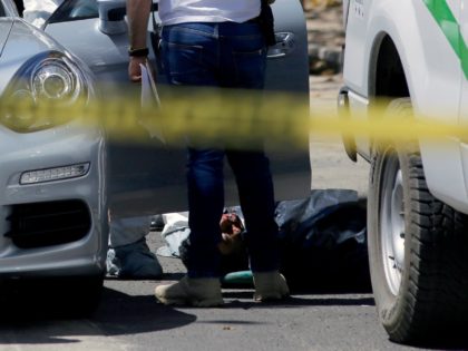 The body of a man shot dead inside his car is removed from the vehicle by forensic personnel in Americana neighbourhood, in the turistic area of Guadalajara, Jalisco State, Mexico, on March 14, 2018. Mexico has suffered a wave of violence linked to drug trafficking that has intensified in recent …