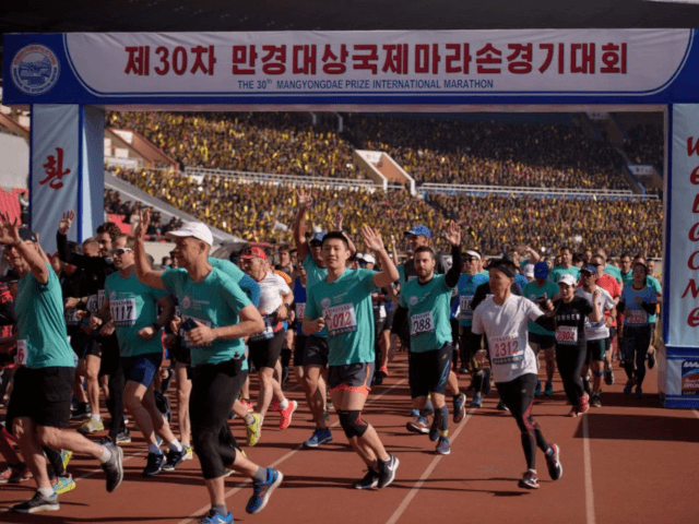 Foreign competitors cross the starting line during the annual 'Mangyongdae Prize International Marathon', at Kim Il Sung stadium in Pyongyang on April 7, 2019. - Twice as many foreigners as last year gathered in Pyongyang for the city's annual marathon, tour firms said, as reduced tensions see visitor numbers rise …