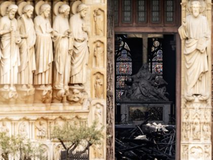 The interior of the Notre-Dame Cathedral is seen through a doorway following a major fire