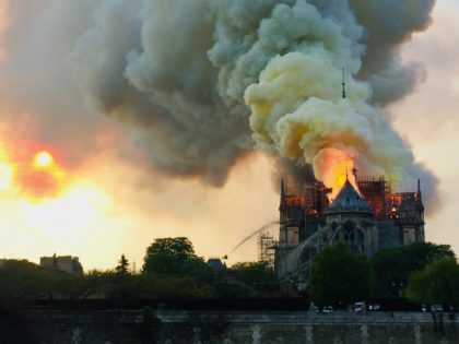 Flames and smoke are seen billowing from the roof at Notre-Dame Cathedral in Paris on April 15, 2019. - A fire broke out at the landmark Notre-Dame Cathedral in central Paris, potentially involving renovation works being carried out at the site, the fire service said.Images posted on social media showed …