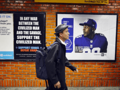 NEW YORK, NY - SEPTEMBER 27: People walk by a controversial ad, which has already been defaced, that condemns radical Islam in a New York subway station on September 27, 2012 in New York City. The ads, which are appearing in New York after a court case ruled in their …