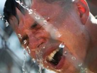 pepper sprayed man washes face