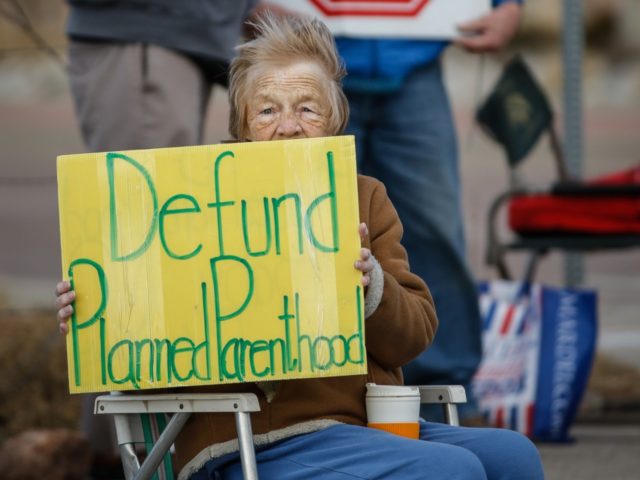 Pro-Life protestor Rose Ann Schienle of Colorado Springs, Colorado holds a sign while demo