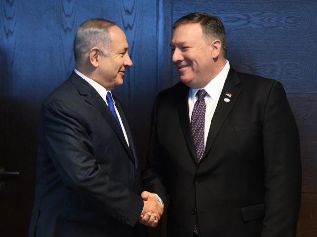 Israel's Prime minister of Benjamin Netanyahu (L) shakes hands with US Secretary of State