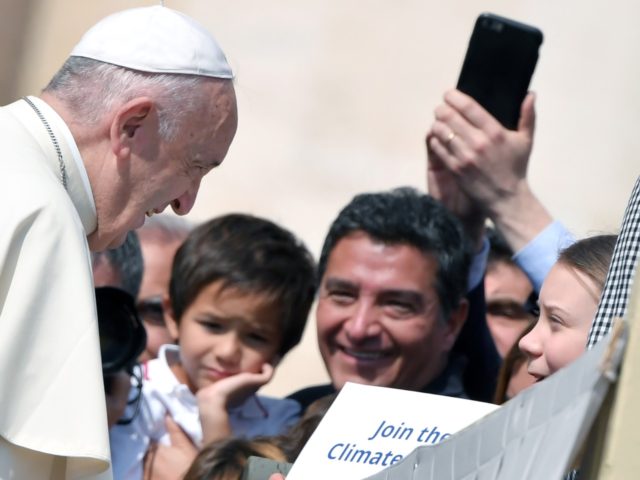 Pope Francis greets Swedish teenage environmental activist Greta Thunberg (R) during a weekly general audience at Saint Peter's square on April 17, 2019. (Photo by Tiziana FABI / AFP) (Photo credit should read TIZIANA FABI/AFP/Getty Images)