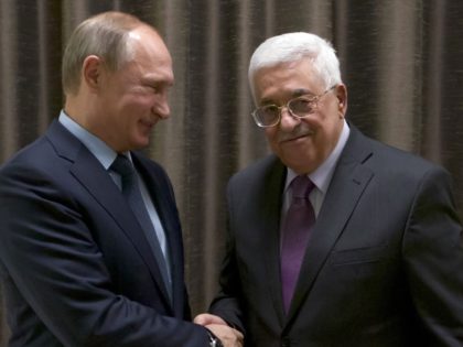 Russian President Vladimir Putin (L) shakes hands with his Palestinian counterpart Mahmud