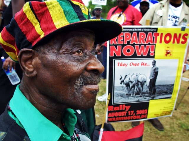 WASHINGTON, DC - AUGUST 17: Borneti Phillipis, 76-years-old, from Wackegan, Illinois, joins hundreds of black demonstrators for slave reparations on the National Mall August 17, 2002 in Washington, DC. Phillips traced back his ancestor, Robson, who was brought to the U.S. as a slave in 1786 from Uganda. (Photo by …