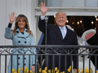 U.S. President Donald Trump (C) delivers remarks from the Truman Balcony with first lady Melania Trump during the 140th annual Easter Egg Roll on the South Lawn of the White House April 2, 2018 in Washington, DC. The White House said they are expecting 30,000 children and adults to participate …