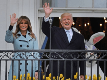 U.S. President Donald Trump (C) delivers remarks from the Truman Balcony with first lady Melania Trump during the 140th annual Easter Egg Roll on the South Lawn of the White House April 2, 2018 in Washington, DC. The White House said they are expecting 30,000 children and adults to participate …