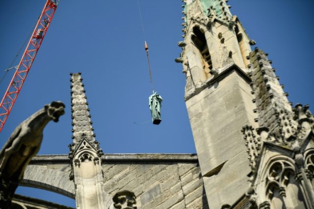 Tourists stunned as Notre-Dame cathedral statues fly above Paris