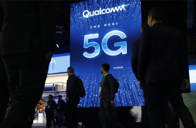 Apple Qualcomm FILE In this Jan. 9, 2019, file photo a sign advertises 5G at the Qualcomm booth at CES International in Las Vegas. Apple and mobile chip maker Qualcomm have settled a bitter financial dispute centered on some of the technology that enables iPhones to connect to the internet. The surprise truce announced Tuesday, April 16, came just as the former allies turned antagonists were facing off in a federal court trial that was supposed to unfold over the next month in San Diego. The resolution abruptly ended that trial. (AP Photo/John Locher, File) The Associated Press