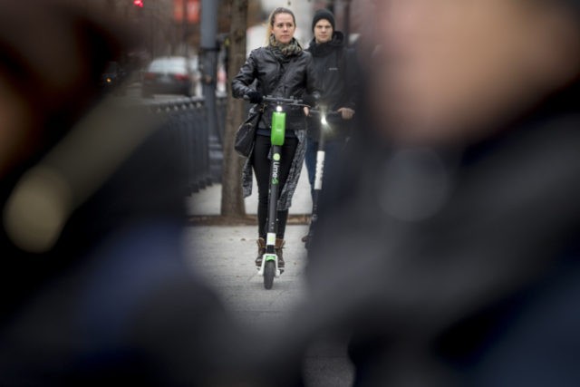 Electric Scooters In this Dec. 4, 2018, photo a couple rides scooters near the White House in Washington. Electric scooters are overtaking station based bicycles as the most popular form of shared transportation outside transit and cars. (AP Photo/Andrew Harnik) The Associated Press